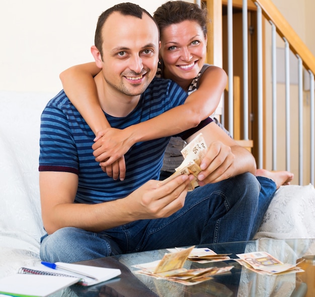 Couple with cash at home