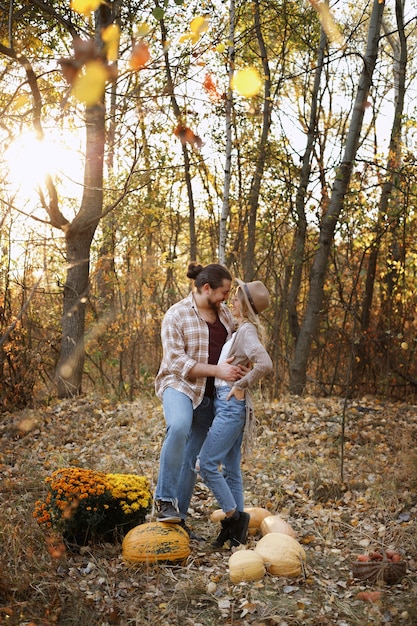 Couple with pumpkins in autumn on a walk