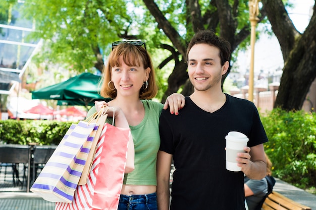 Couple with shopping bags walking on the streets.