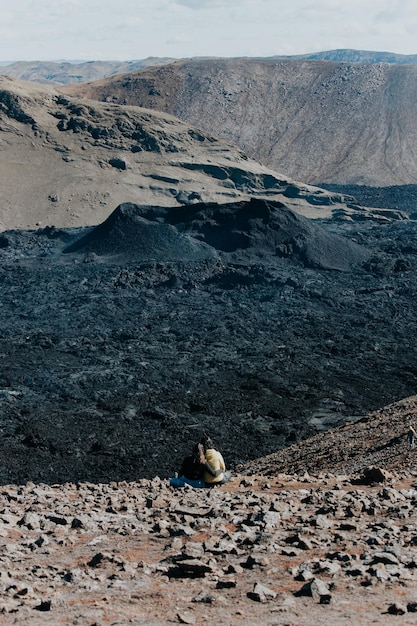 Couple of woman in front of the Fagradalsfjall active volcano in Iceland Travelers and hikers Love in Iceland Visit Iceland and their natural paradise concept Travel and road trip style