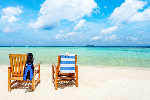 Couple of wooden chair standing on a beach Indian Ocean