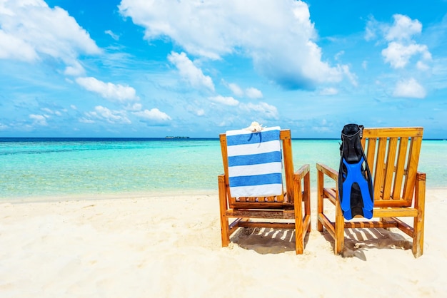 Couple of wooden chair standing on a beach Indian Ocean