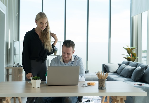 couple working on laptop computer with relax and happiness smile face working at home concept