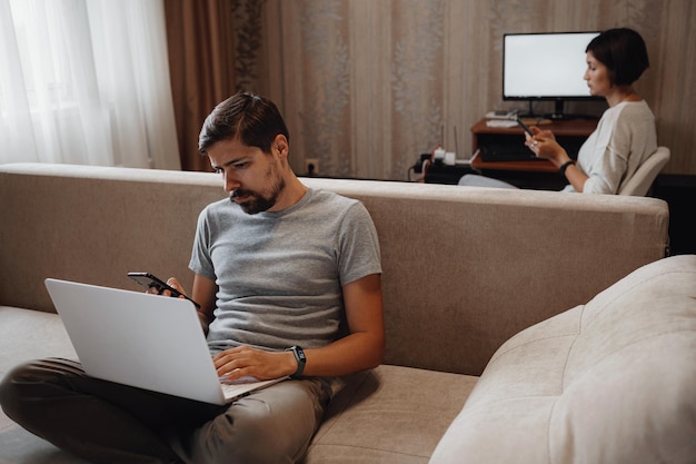 Couple Working And Playing With Laptop Computer At Home