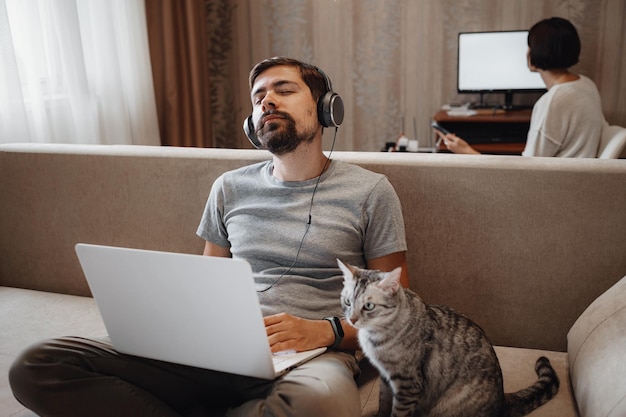 Couple Working And Playing With Laptop Computer At Home