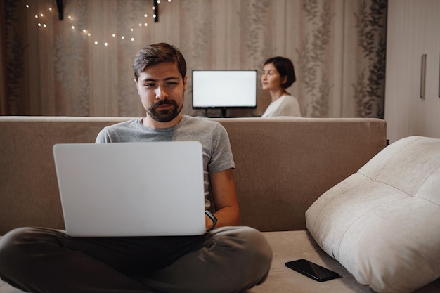 Couple Working And Playing With Laptop Computer At Home