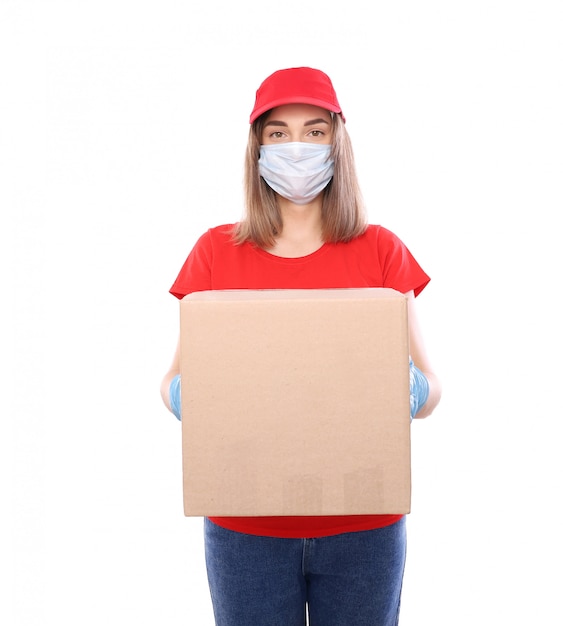 Courier woman in mask and gloves with box isolated on white. Courier catering. Post office. Stay at home