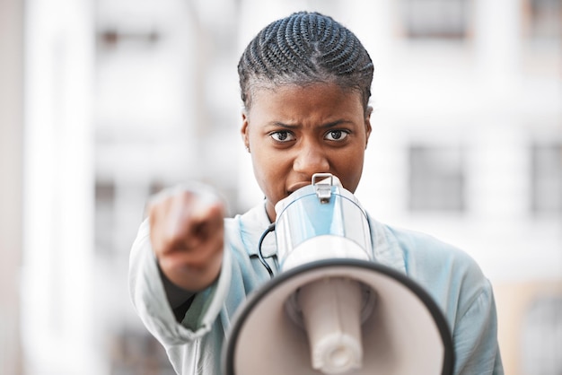 Of course I am not worried about intimidating men Shot of a young woman screaming into a loud speaker while protesting in the city