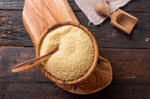 Couscous grain in wooden bowl