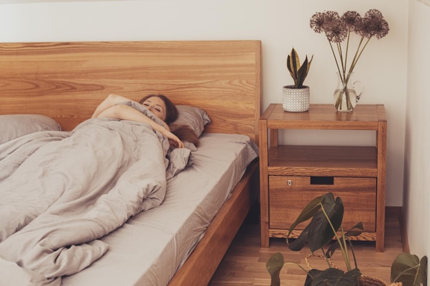 Covered woman with protruding hands out of blanket