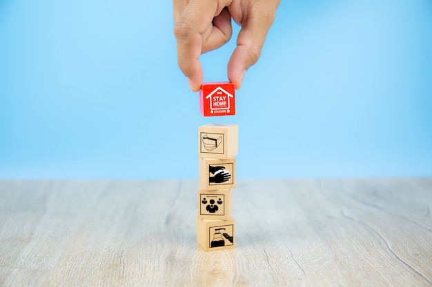 Covid-19 icon on wooden toy block. Concepts for health care and prevention of coronavirus.