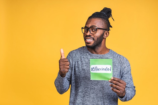 Covid-19 Vaccination Concept. African American black Man After Coronavirus Vaccine Injection Shot, Vaccinated Black Guy Isolated Over yellow Background.