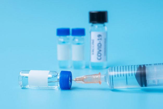 COVID-19 Vaccine vial and injection Needle Syringe against Coronavirus infection in hospital laboratory. Medical, health, Vaccination and immunization concept