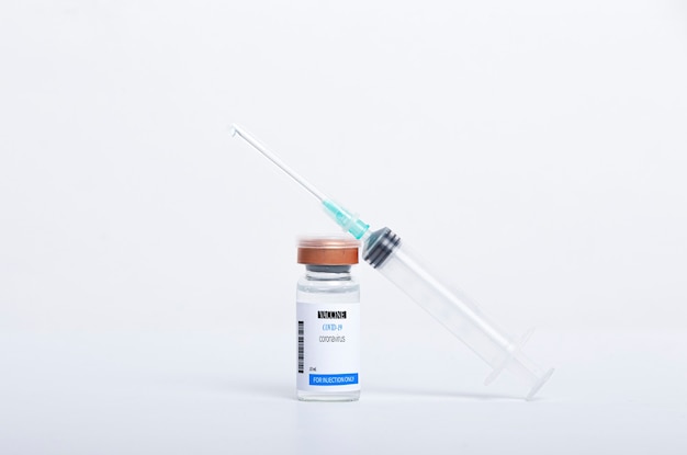 Covid -19 vaccine vial and syringe for injection isolated