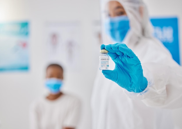 Covid corona virus vaccine or vaccination with healthcare worker hands showing liquid glass container or bottle Medical doctor preparing a coronavirus prevention dosage shot for patient in hospital