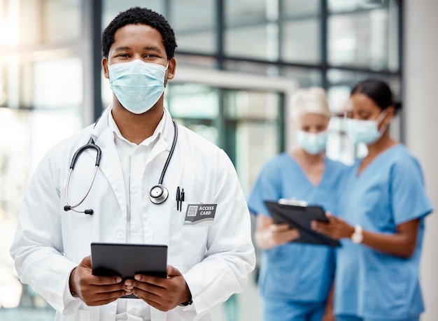 Covid healthcare and African doctor with a tablet for online consulting agenda and planning on tech at hospital Medical portrait and surgeon with technology for schedule and face mask at a clinic