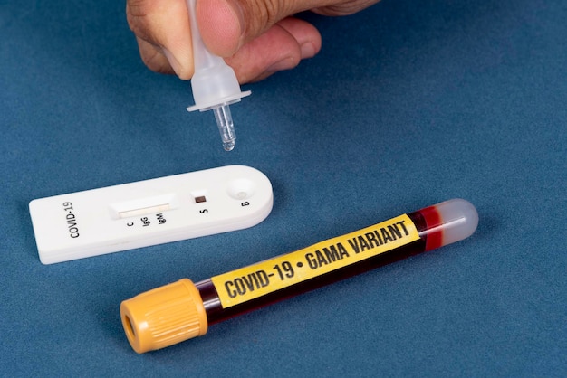 Covid19 rapid test with person dripping the reagent