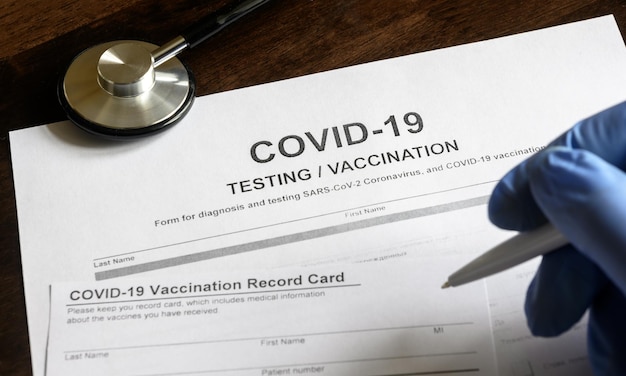 COVID19 testing and vaccination forms on desk