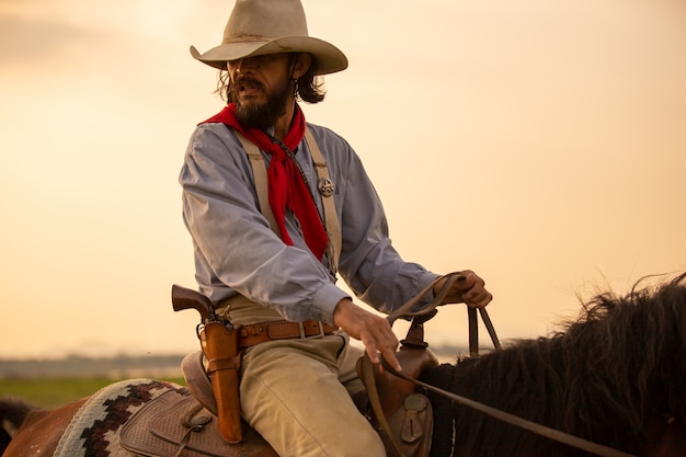 Cowboy on horseback against a beautiful sunset