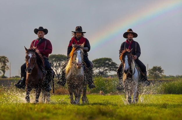 Cowboys riding horses beside the river and lifestyle with natural light background