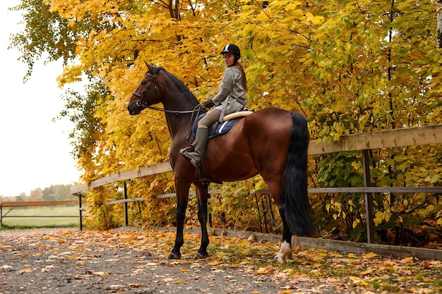 Cowgirl in a cowboy hat rides a horse on the background of the forest Motion blur effect