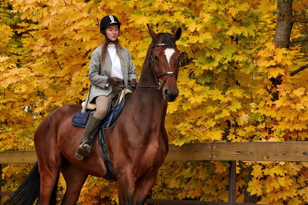 Cowgirl in a cowboy hat rides a horse on the background of the forest Motion blur effect