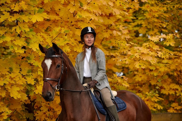 Cowgirl in a cowboy hat rides a horse on the background of the forest Motion blur effect