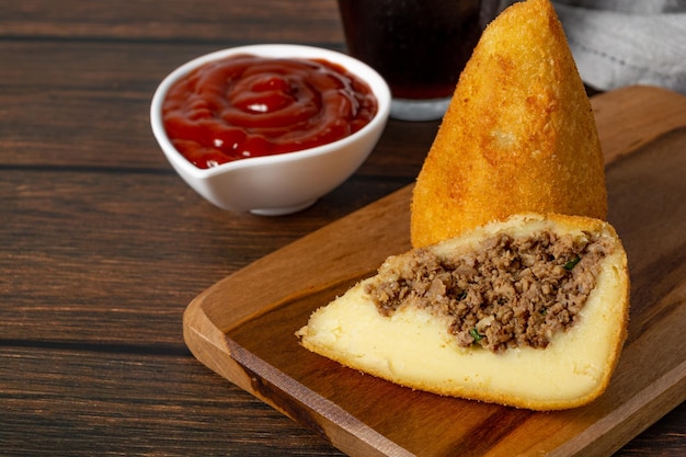 coxinha, brazilian fried snack cut in half