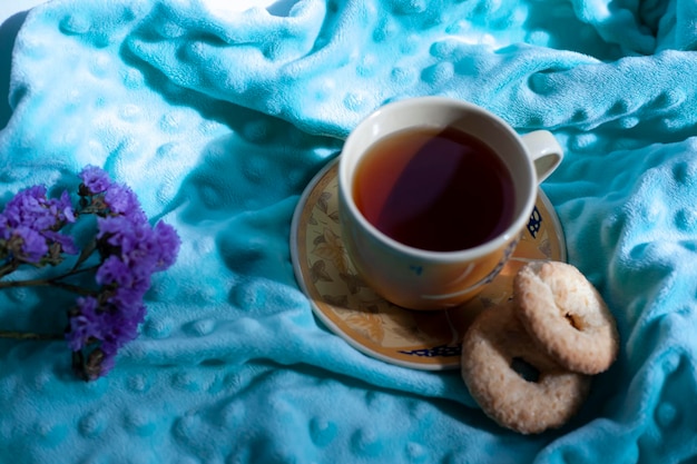 Cozy autumn composition with a large cup of coffee and cute decor details in the bed