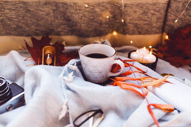 Cozy autumn morning with cup of coffee with cream and autumn leaves 