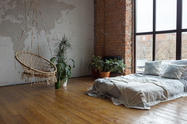 Cozy bedroom interior with wide bed, big windows. staying home during quarantine