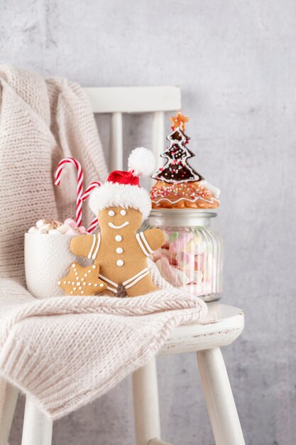 Cozy christmas composition with a cup and cookies. Hot chocolate with marshmallow.