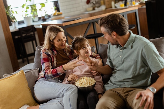 Cozy family time sharing laughter and popcorn on a casual evening