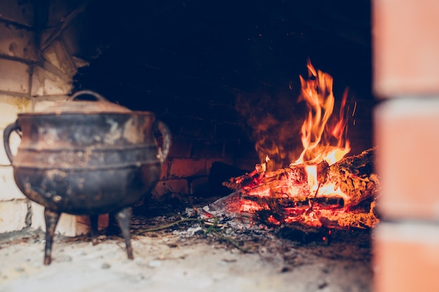 Cozy fire in a stone fireplace with jug