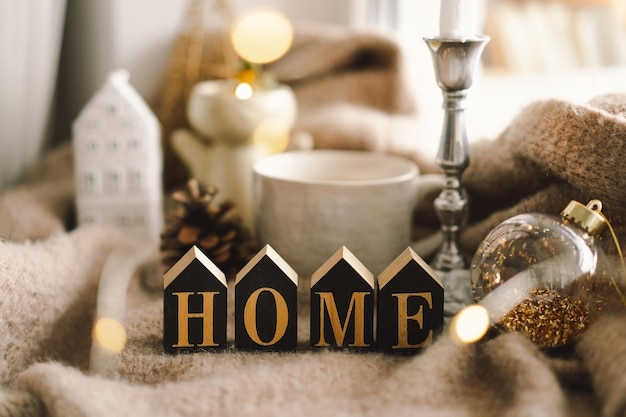 Cozy home Christmas composition Hot tea candles Christmas golden balls and decorations Sweet home Home concept