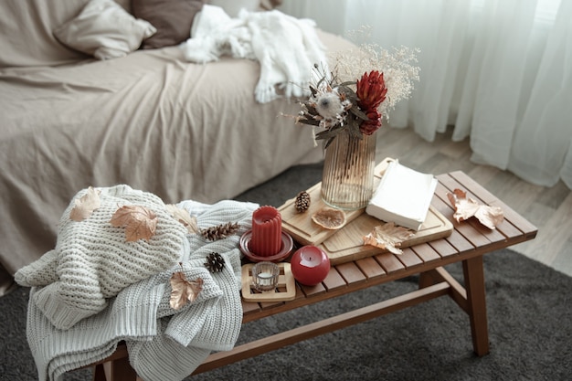 A cozy home composition with candles a book knitted sweaters