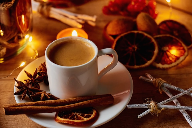 Cozy home. Cup of coffee with a festive decorations and fairy garland lights