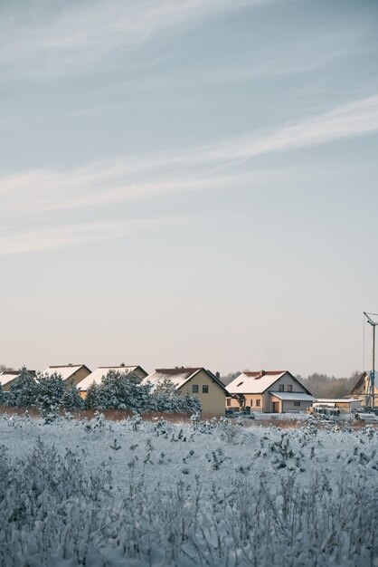 Cozy home exterior in winter Wooden house in a nature area covered with freshly fallen snow