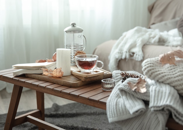 Cozy home still life with a cup of tea and details of autumn home decor.