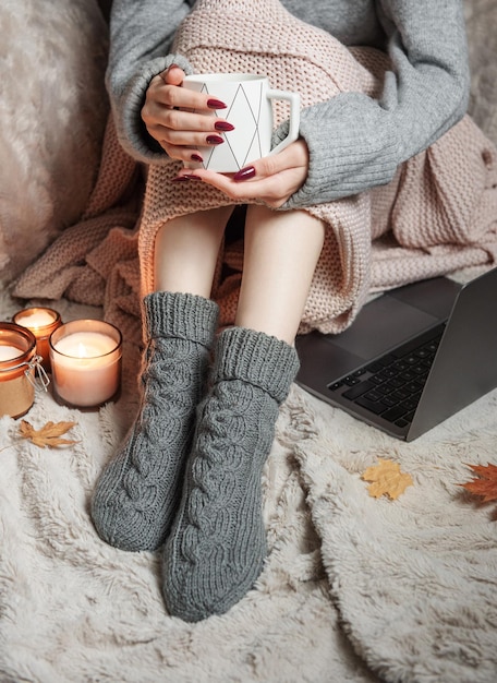 Photo cozy home woman covered with warm blanket drinks coffee