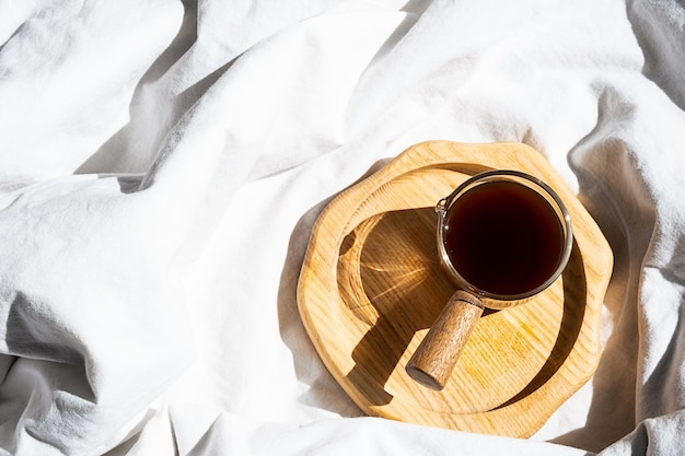 Cozy homely scene with coffee cup in bed Morning concept