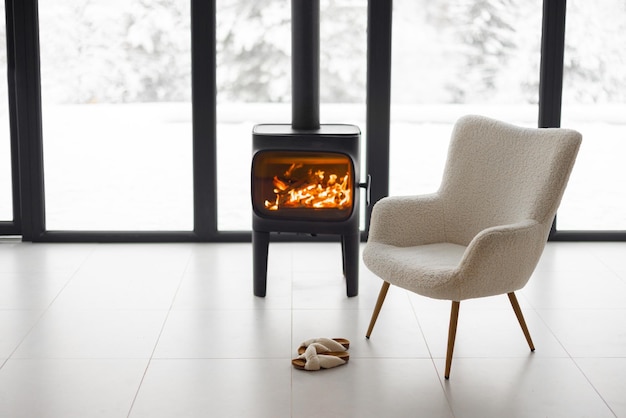 Cozy living space by the burning fireplace at snowy mountains