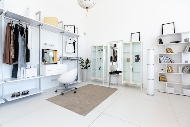 Cozy luxury modern interior design of a studio apartment in extra white colors with fashionable expensive furniture in a minimalist style.