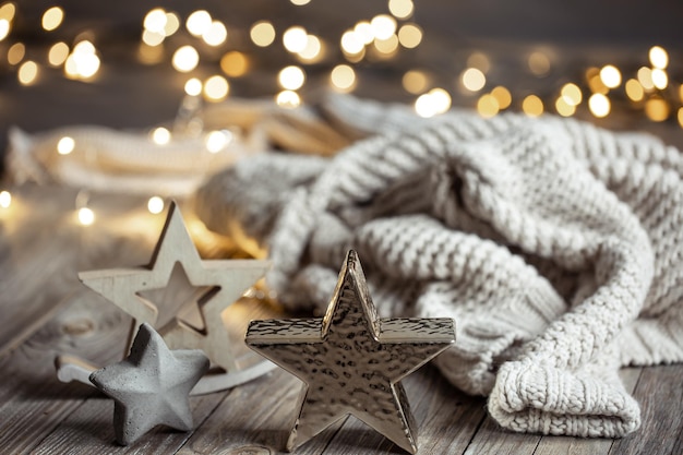 Cozy winter composition with decor details on blurred background with bokeh