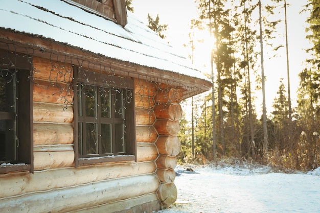 Cozy wooden house with snow in winter day