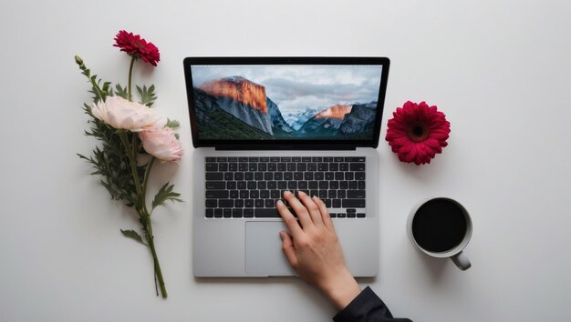 Photo a cozy workspace with a laptop coffee and vibrant flowers