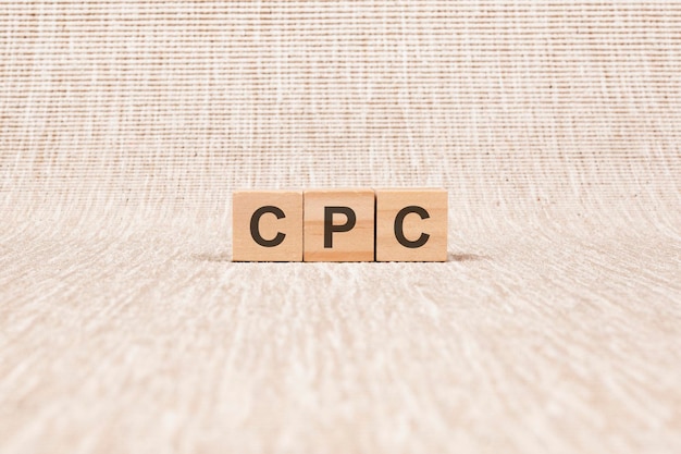 CPC word written on wood blocks text on broun backgrond for your desing concept CPC  short for cost per click