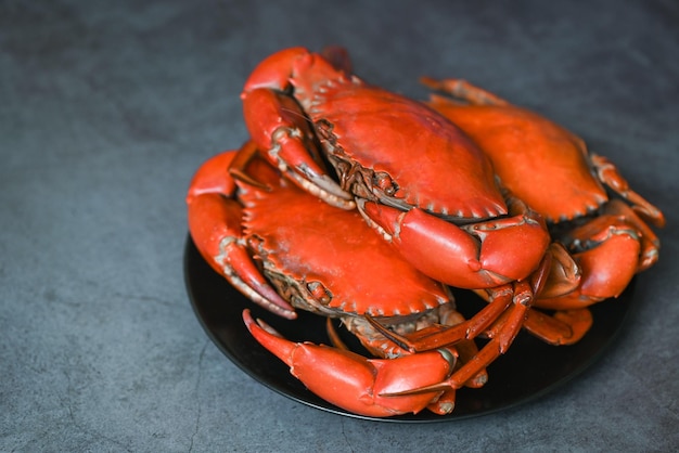 crab seafood plate with, fresh crab on black plate, crab cooking food boiled or steamed crab red in the restaurant