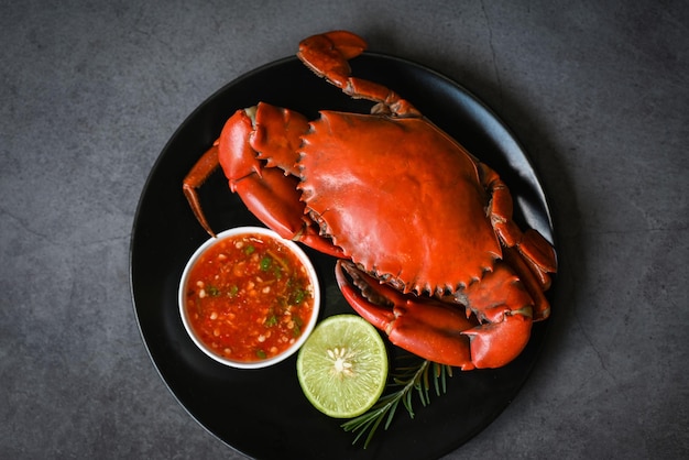 crab seafood plate with, fresh crab on black plate, crab cooking food boiled or steamed crab red in the restaurant