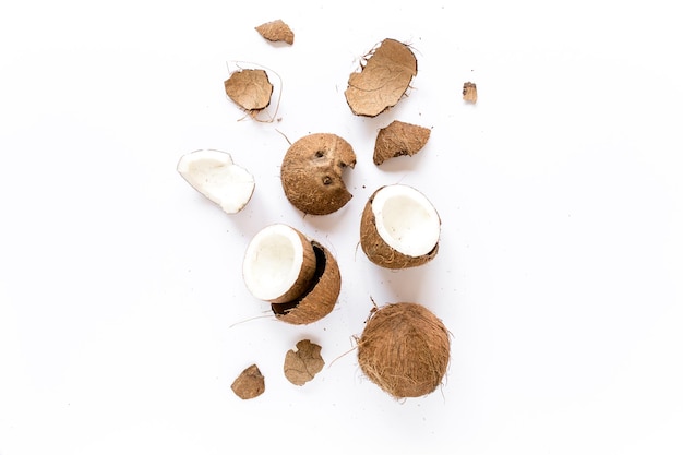 Cracked coconut on white background flat lat top view